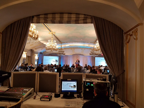 man at desk webscasting during a speaking event