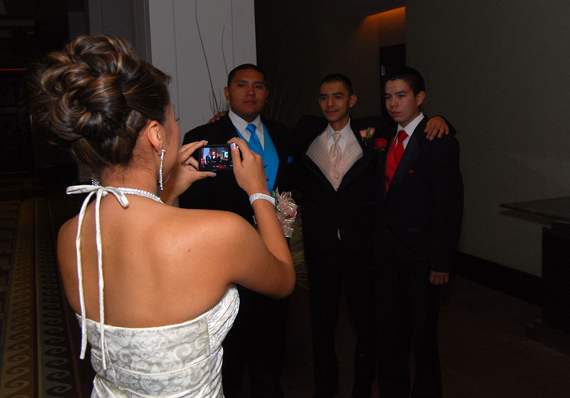 bride taking a photo of groomsmen