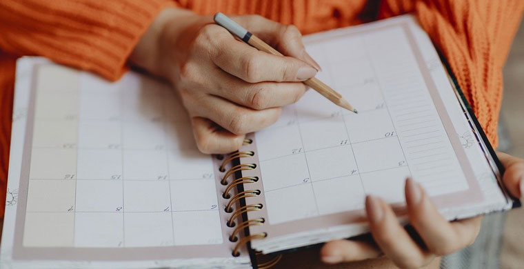 person writing in planner