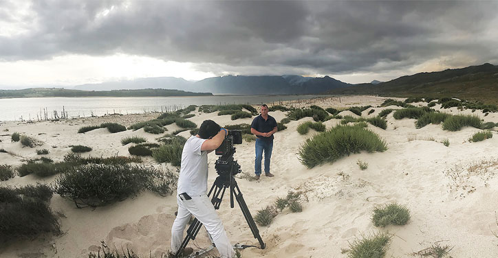 man being filmed on beach