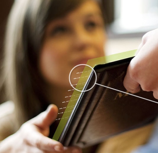 Women getting handed a tablet